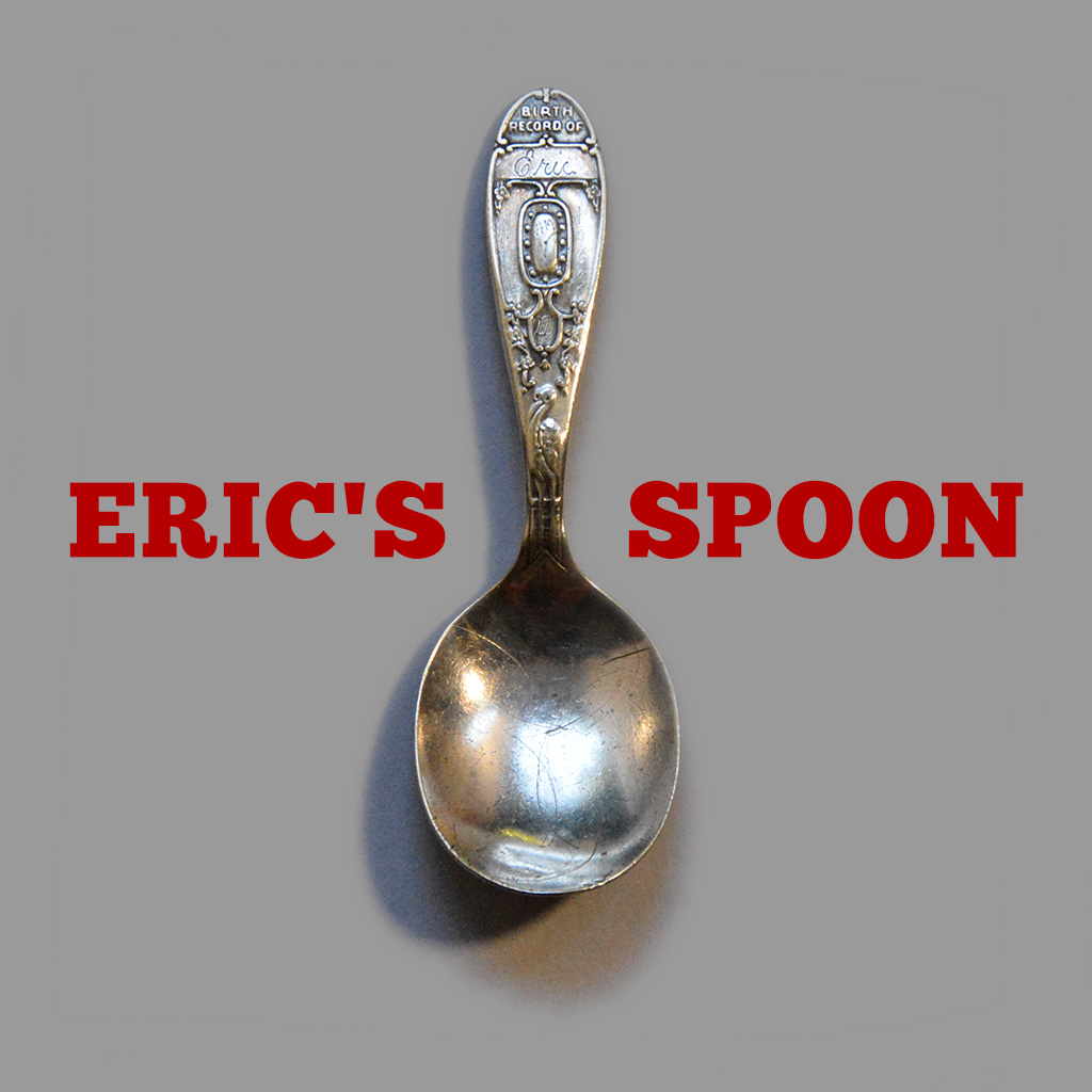 A silver birth record spoon engraved with Eric's name